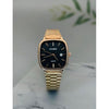 Aesthetic gold square digital watch worn on wrist, blending 80s vintage style with modern streetwear fashion.