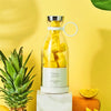 Fresh Pineapple Juice in Portable Blender Bottle with Yellow Background