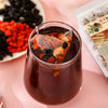 A fresh cup of Ginseng Five Treasure Tea in a glass, showing the rich color and steeped herbs for daily wellness and stamina.