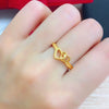 Close up of a female hand wearing a gold double heart ring - Zalviro Jewelry collection