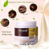 Decorative layout of the organic hair treatment container surrounded by natural plant leaves and rich cream drops.