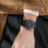 Side profile of a sleek black metallic wristwatch showing the slim case and link bracelet - Zalviro