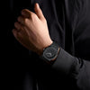 Detailed close-up of the black watch face with subtle silver hands and hour markers - Zalviro